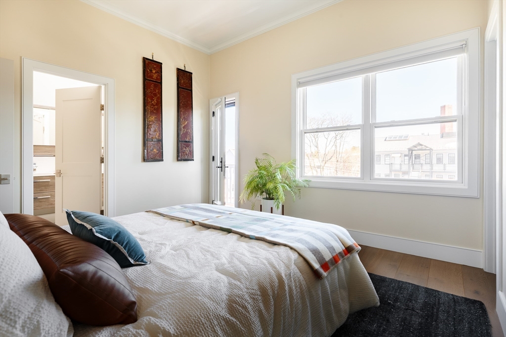 11 Tannery Brook Row, Unit 3 Somerville, MA 02144 - Photo 13 of 20 a bedroom with a bed and a window