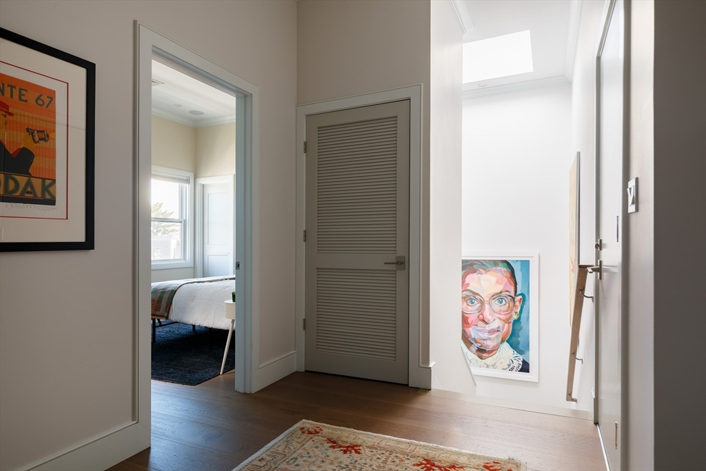 11 Tannery Brook Row, Unit 3 Somerville, MA 02144 - Photo 16 of 20 a view of a hallway with wooden floor and closet