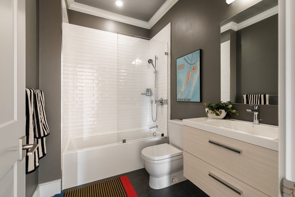 11 Tannery Brook Row, Unit 3 Somerville, MA 02144 - Photo 19 of 20 a bathroom with a sink a toilet and a bathtub