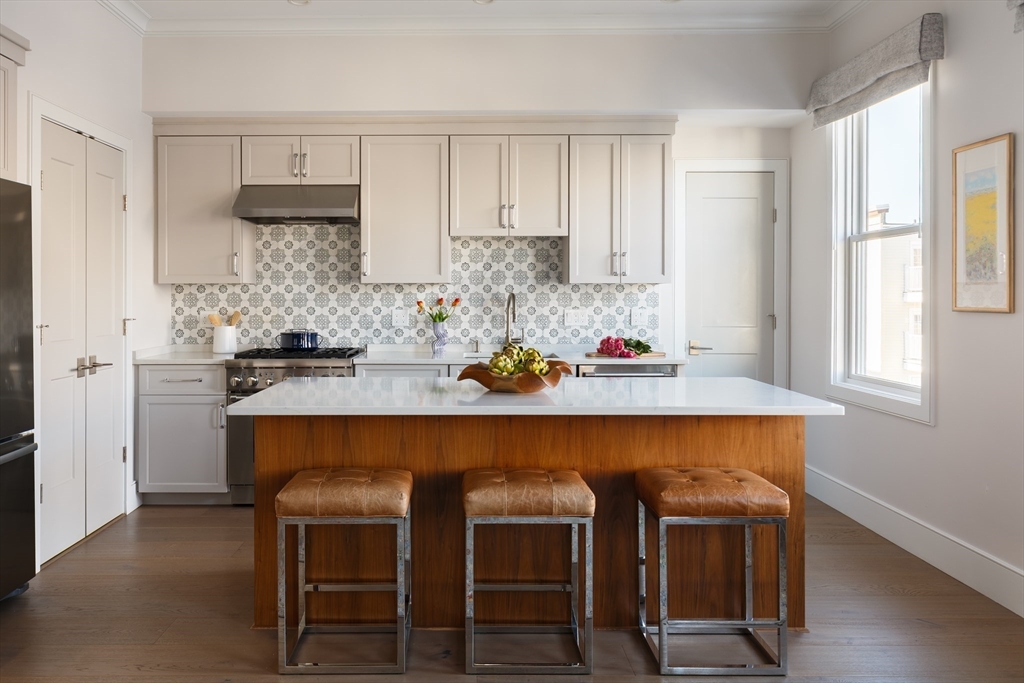 11 Tannery Brook Row, Unit 3 Somerville, MA 02144 - Photo 2 of 20 a kitchen with a table and chairs in it