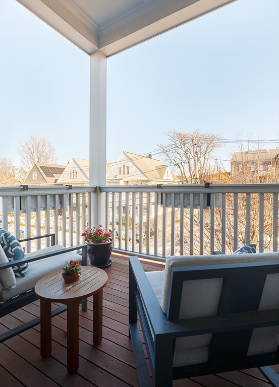 11 Tannery Brook Row, Unit 3 Somerville, MA 02144 - Photo 6 of 20 a view of a balcony with a table and chairs