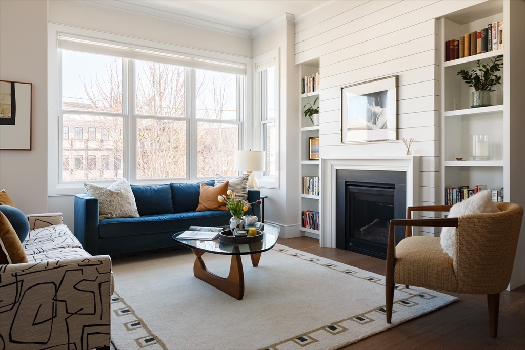 11 Tannery Brook Row, Unit 3 Somerville, MA 02144 - Photo 7 of 20 a living room with furniture a window and a fireplace