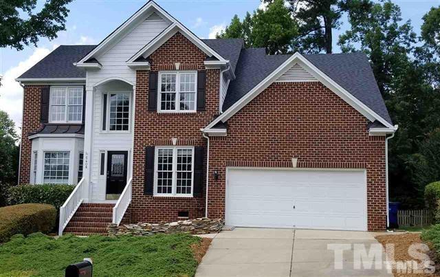 5408 Calverton Drive Raleigh, NC 27613 - Photo 1 of 4 a front view of a house with a yard and garage
