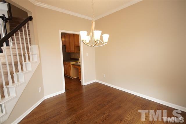 5408 Calverton Drive Raleigh, NC 27613 - Photo 2 of 4 a view of a hallway with wooden floor and staircase