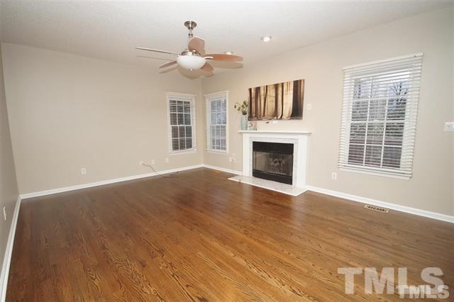 5408 Calverton Drive Raleigh, NC 27613 - Photo 3 of 4 a view of an empty room with wooden floor and a window