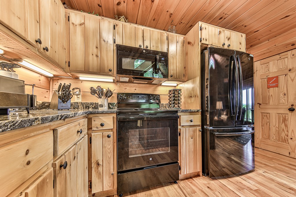 88 Black Gum Lane Blue Ridge, GA 30513 - Photo 22 of 85 a kitchen with stainless steel appliances granite countertop a refrigerator stove and microwave