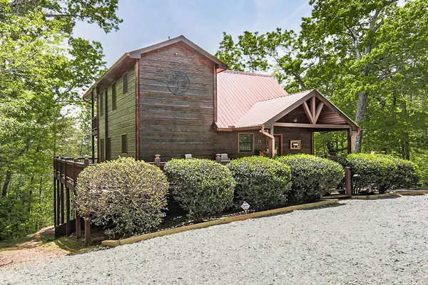 a view of a patio with table and chairs with wooden floor and plants