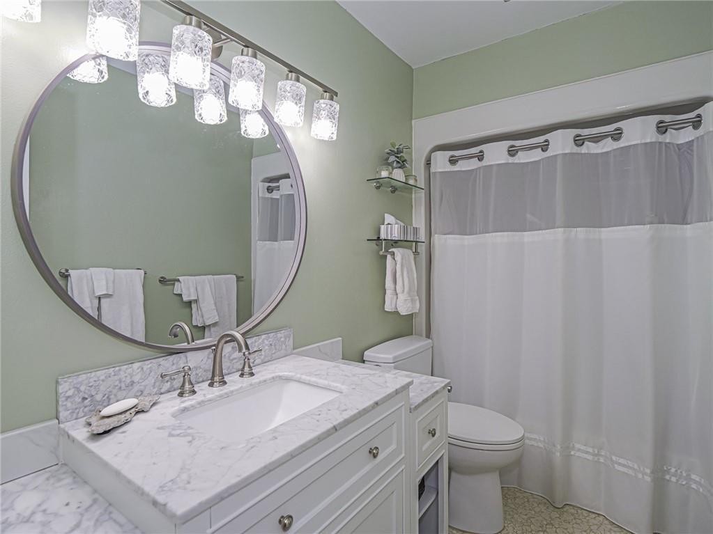 1 Vista Palm Lane, Unit 207 Vero Beach, FL 32962 - Photo 17 of 36 a bathroom with a sink vanity mirror and toilet