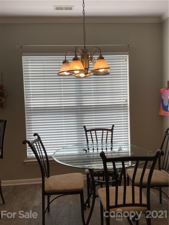 388 Sand Paver Way Fort Mill, SC 29708 - Photo 7 of 20 a view of a dining room with furniture and chandelier