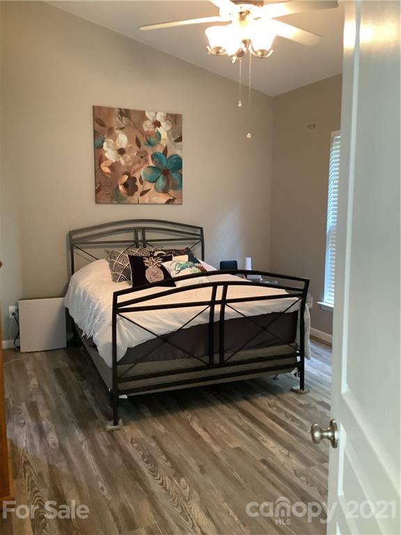 388 Sand Paver Way Fort Mill, SC 29708 - Photo 8 of 20 a bedroom with bed and a chandelier