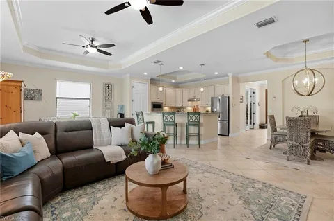 a living room with furniture and kitchen view
