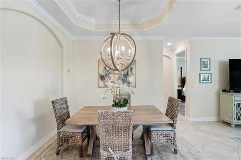 a view of a dining room with furniture and a chandelier