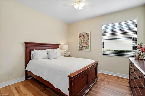 a large bed sitting in a bedroom next to a window