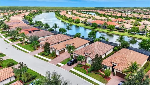 an aerial view of residential houses with outdoor space and river