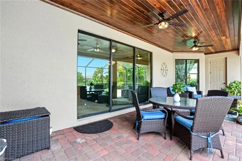 a building outdoor space with patio furniture and potted plants