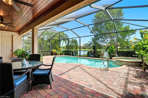 a view of backyard with swimming pool and outdoor seating