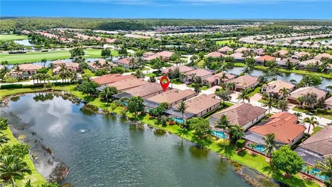 an aerial view of residential houses with outdoor space and river