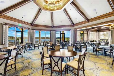 a view of a dining hall with lots of furniture and white walls