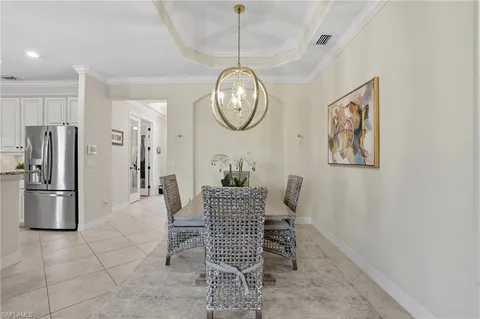 a kitchen with white cabinets and refrigerator