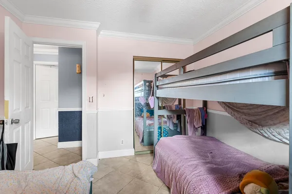 a bedroom with a bed and a mirror