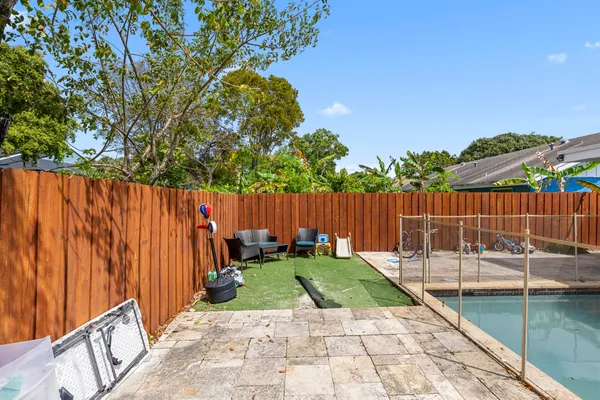 a view of a backyard with a wooden fence