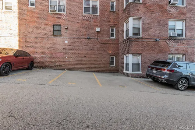 a view of a car parked in front of a brick building