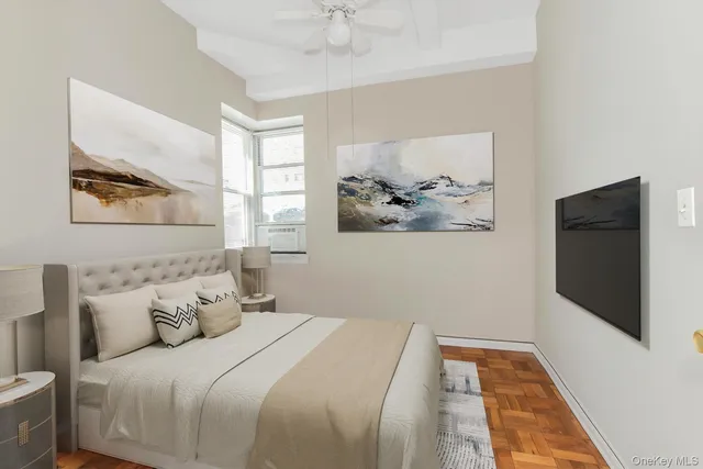 a bedroom with a bed and a painting on the wall