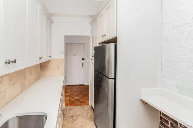 a kitchen with a refrigerator and a sink