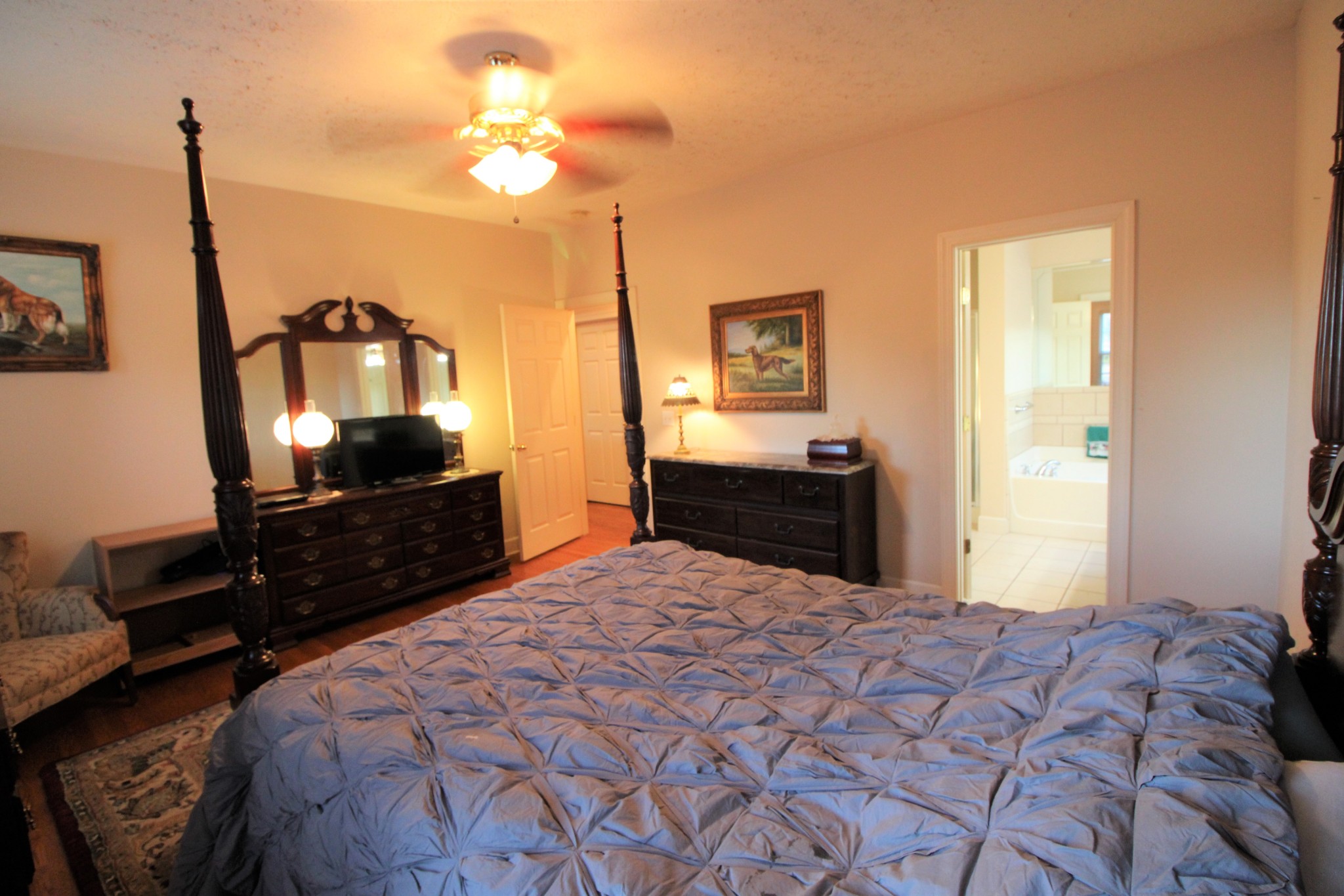 248 West Hester Road Cottontown, TN 37048 - Photo 13 of 22 a bedroom with a bed and a mirror on dresser