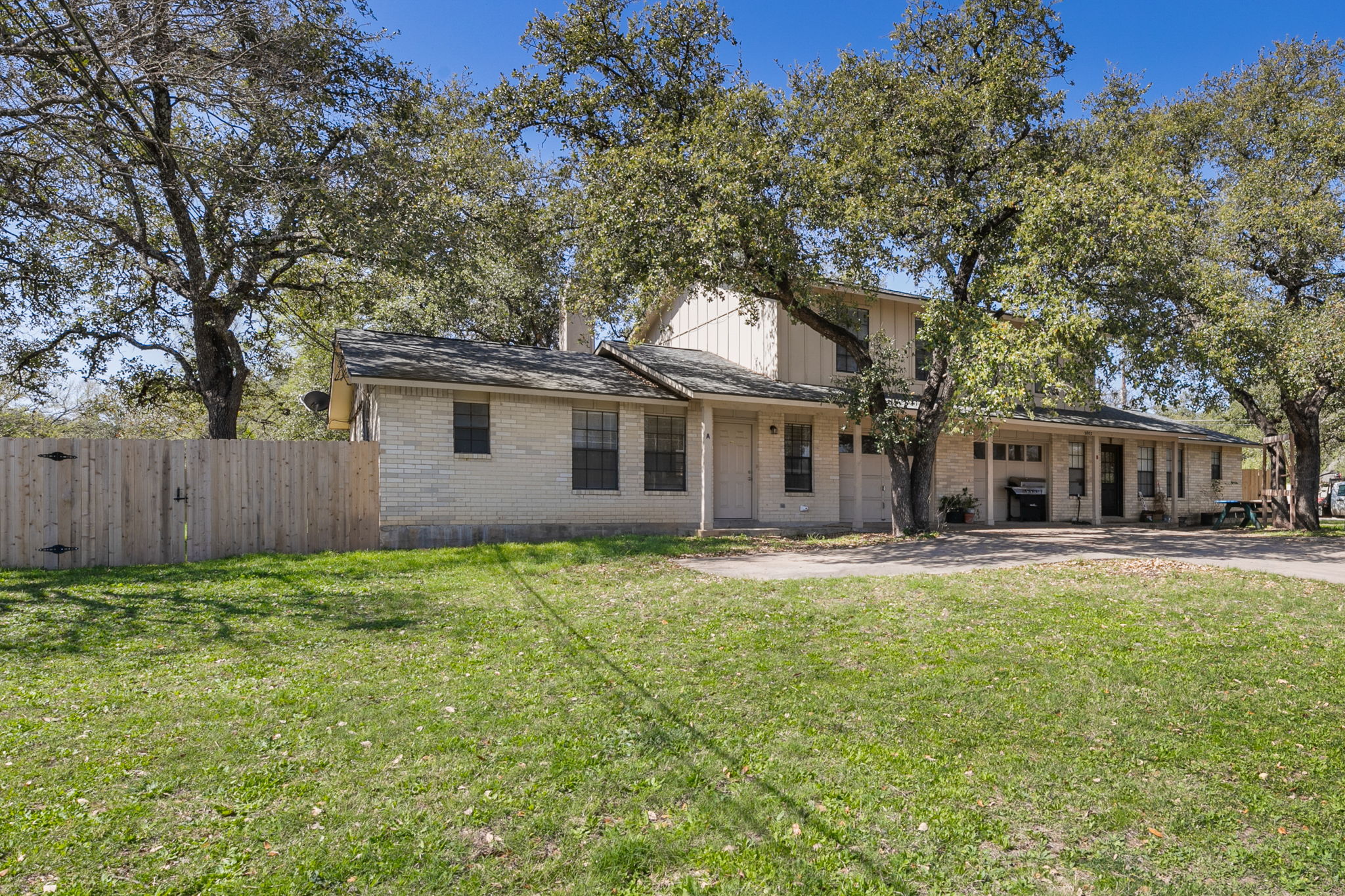 3802 Foust Trail, Unit A Georgetown, TX 78628 - Photo 3 of 34 A classic brick exterior home, shaded by mature trees, presents a welcoming curb appeal.