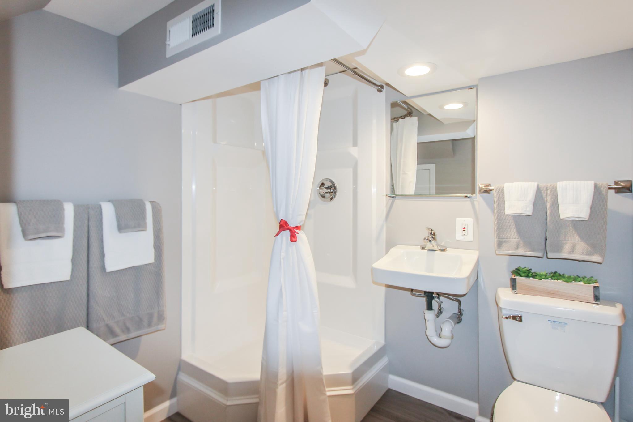9108 Eton Road Silver Spring, MD 20901 - Photo 33 of 43 New 3-piece basement bathroom w/ linen closet.