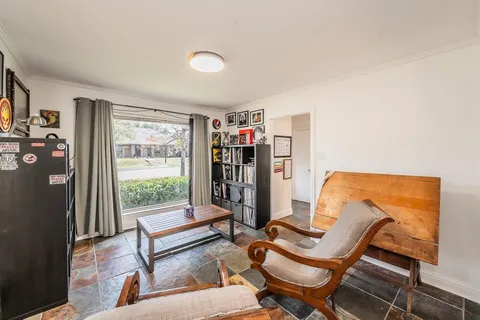 a living room with furniture and a floor to ceiling window