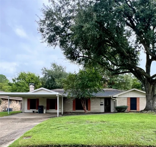 a view of a house with a yard and sitting area