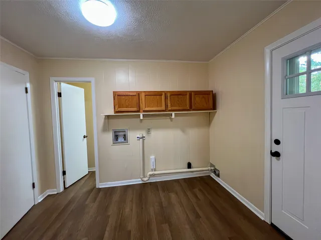 an empty room with wooden floor and closet