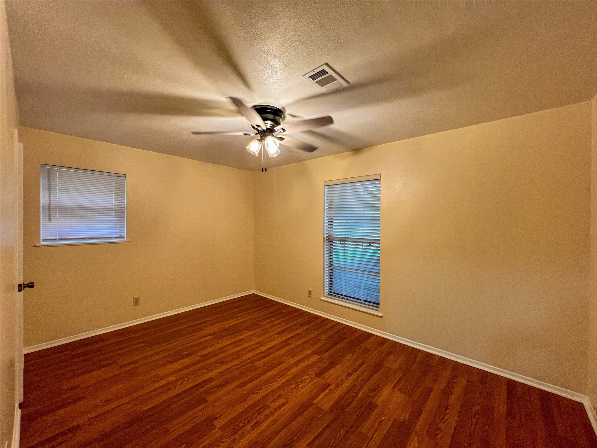 8610 Overhill Lane Beaumont, TX 77707 - Photo 16 of 20 a view of an empty room with wooden floor