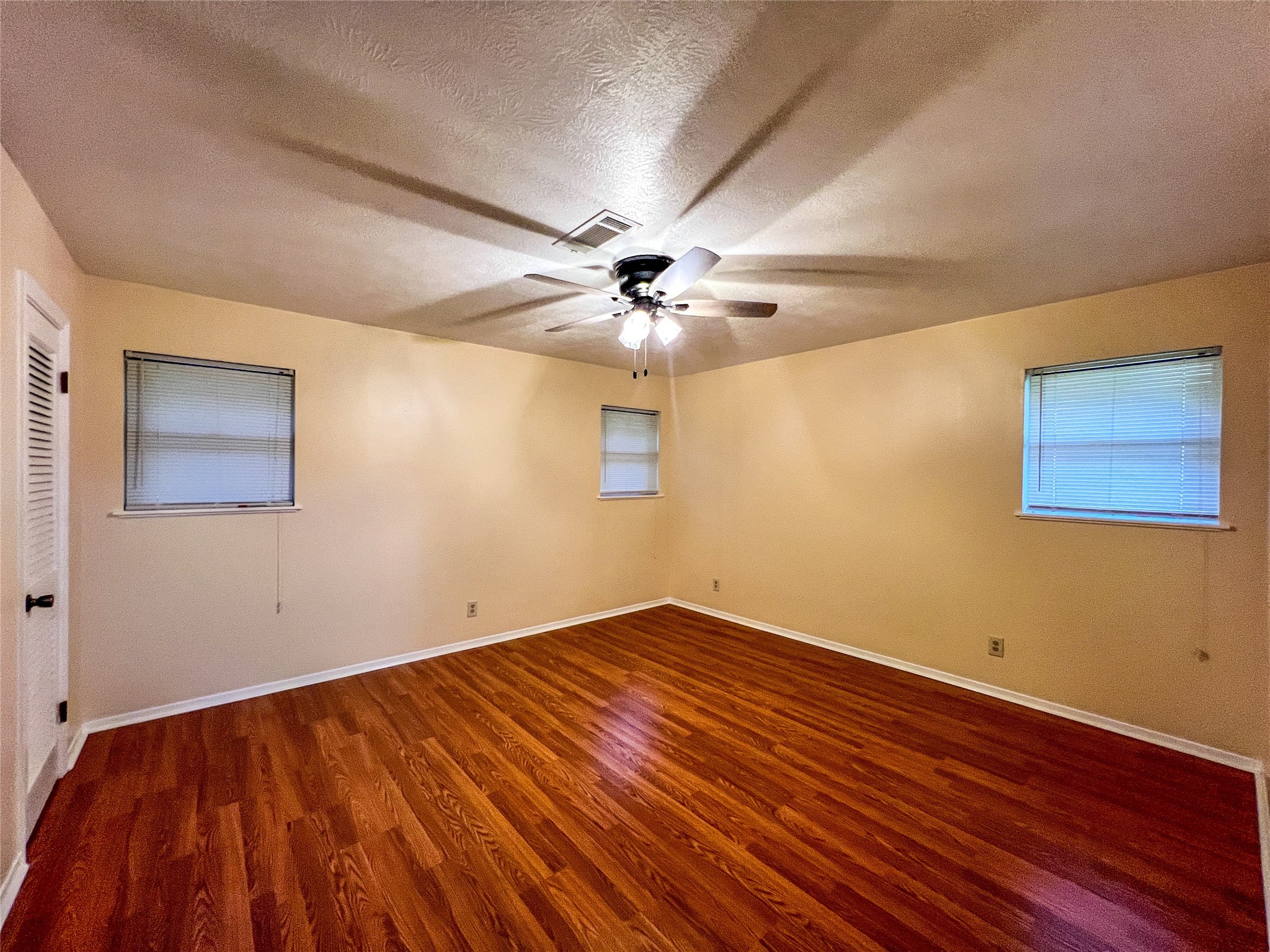 8610 Overhill Lane Beaumont, TX 77707 - Photo 17 of 20 a view of an empty room with wooden floor