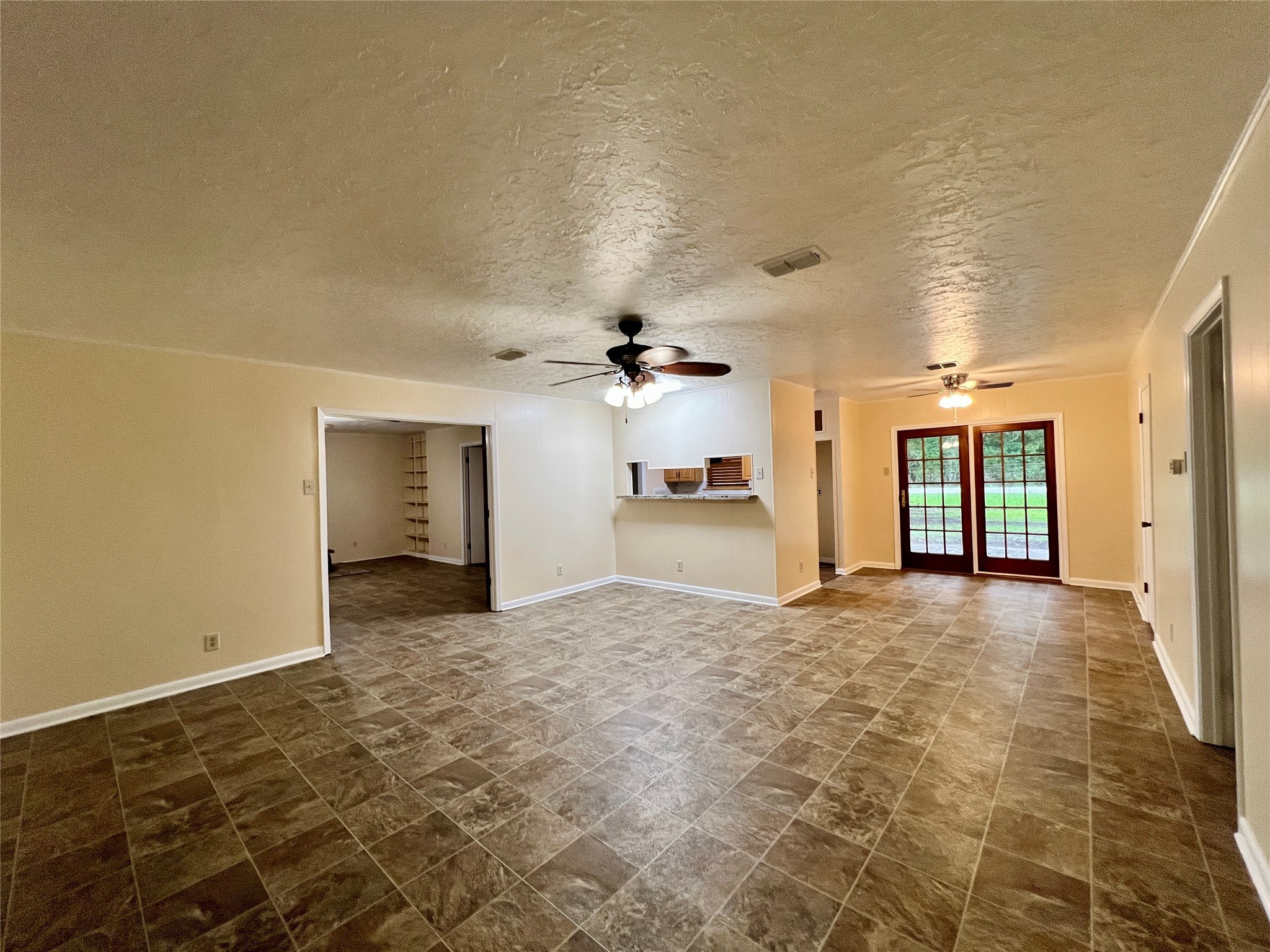 8610 Overhill Lane Beaumont, TX 77707 - Photo 5 of 20 a view of a big room with windows and chandelier fan