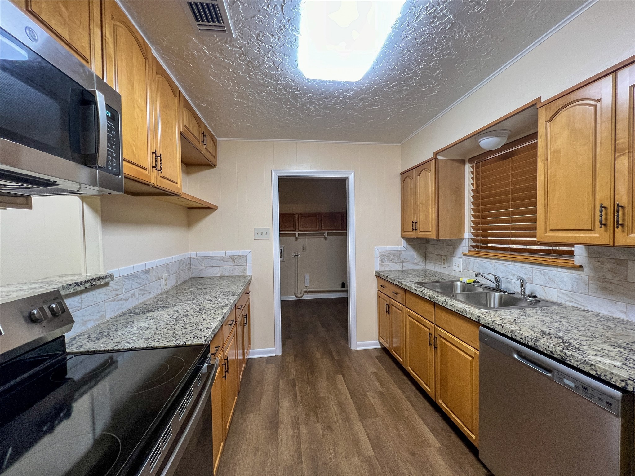 8610 Overhill Lane Beaumont, TX 77707 - Photo 10 of 20 a kitchen with granite countertop stainless steel appliances and wooden cabinets