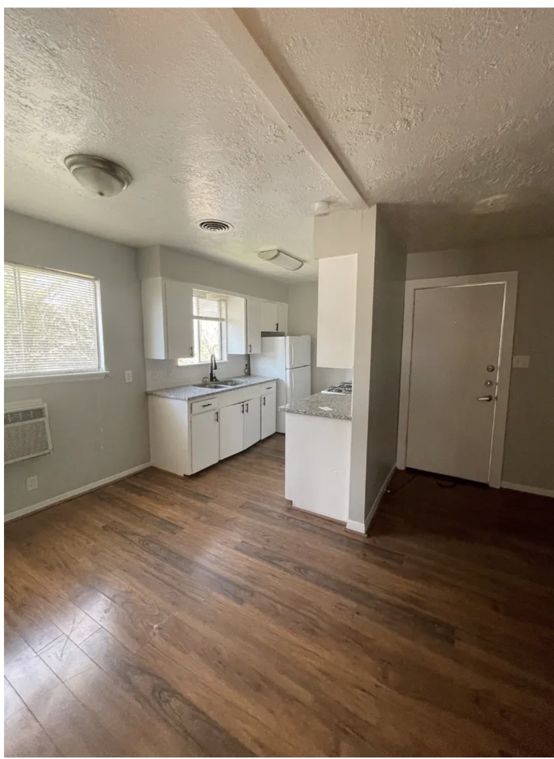 1014 East 23rd Street, Unit 3 Bryan, TX 77803 - Photo 4 of 8 an empty room with wooden floor and windows