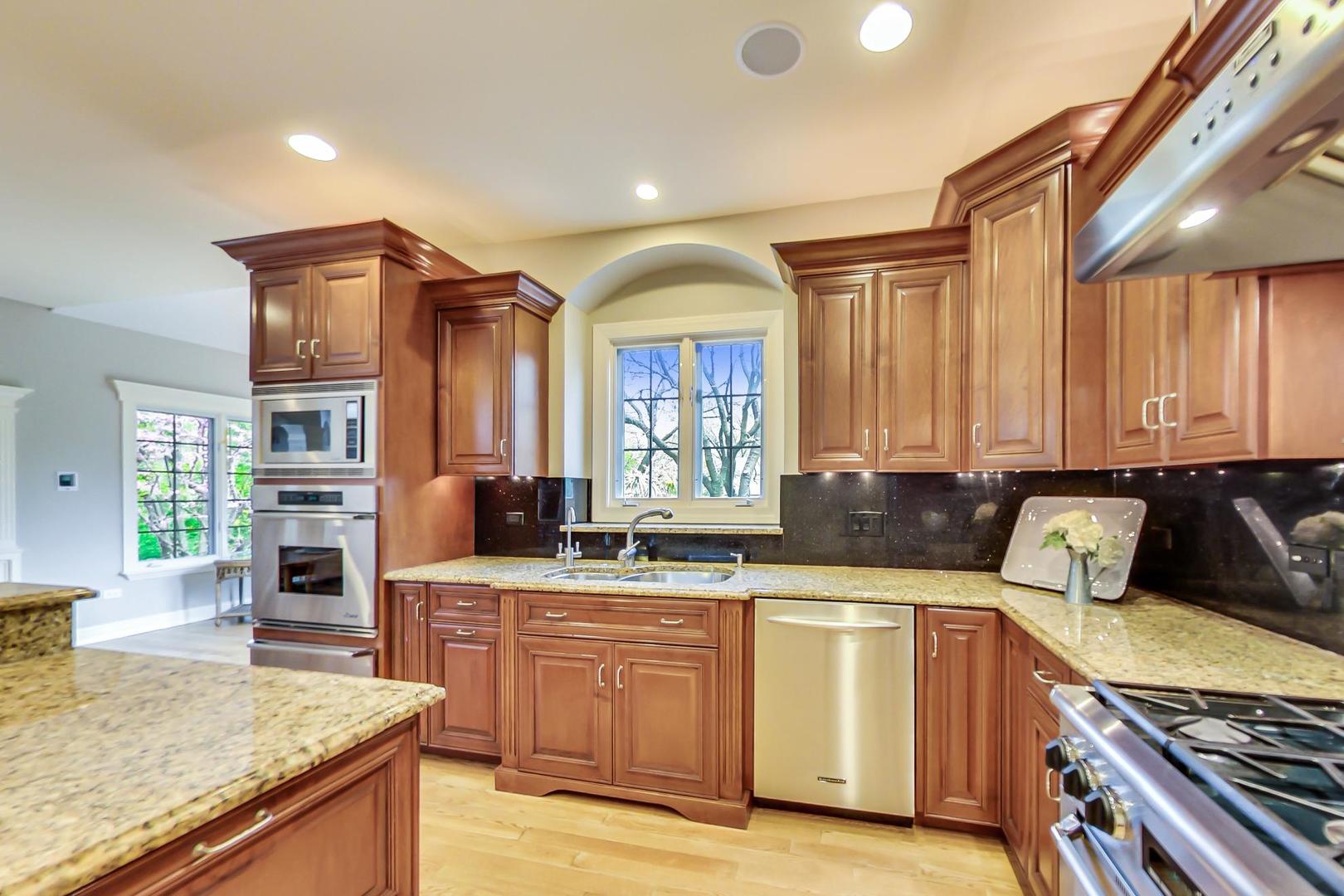 3312 Keller Lane Naperville, IL 60565 - Photo 12 of 50 a kitchen with stainless steel appliances granite countertop a stove and a sink