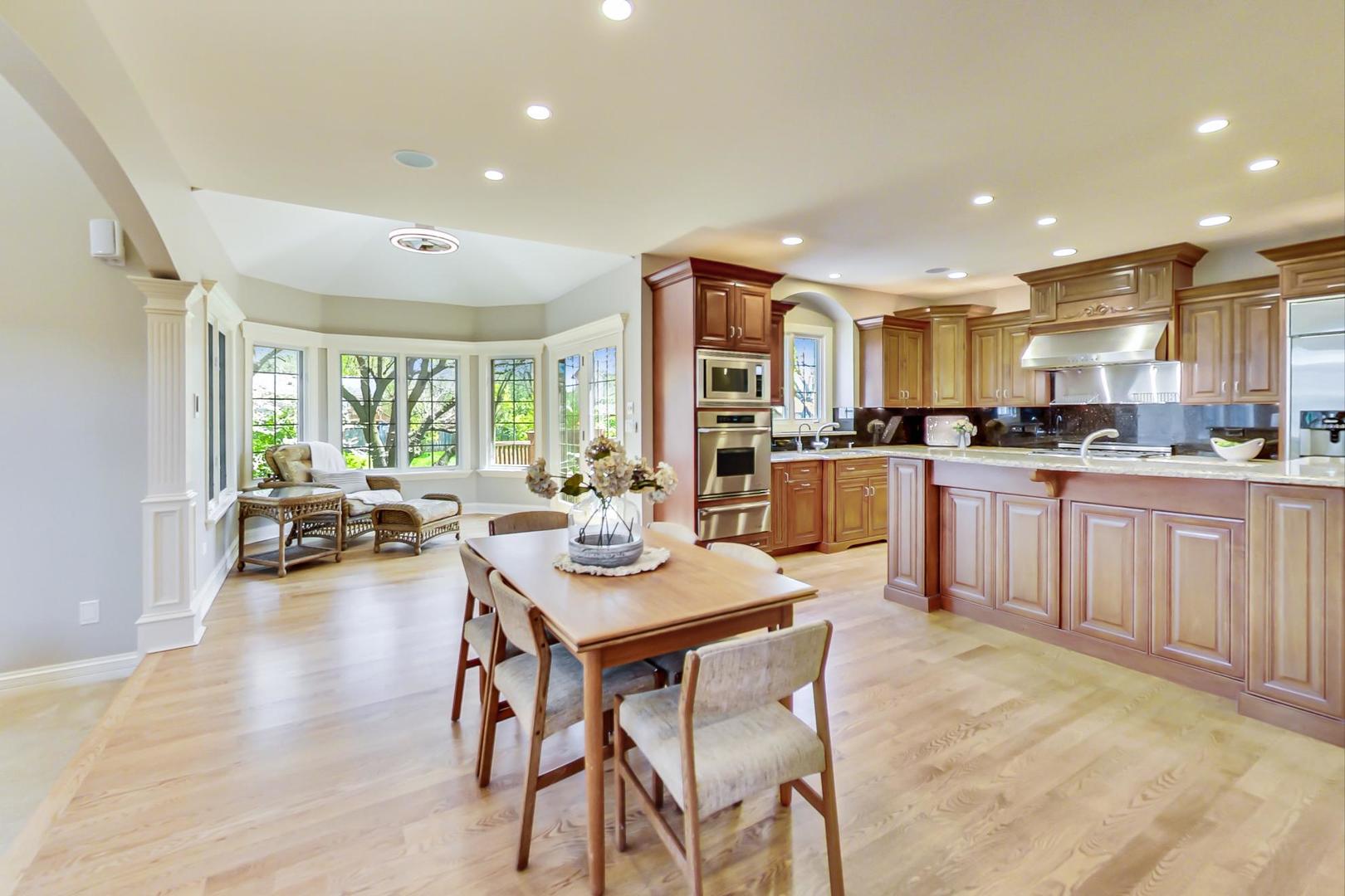3312 Keller Lane Naperville, IL 60565 - Photo 16 of 50 a kitchen with a table chairs refrigerator and cabinets