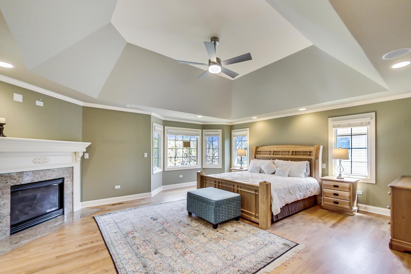 3312 Keller Lane Naperville, IL 60565 - Photo 24 of 50 a bedroom with a bed wooden floor and a fireplace