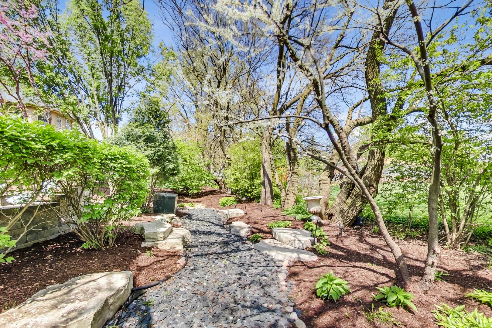 3312 Keller Lane Naperville, IL 60565 - Photo 50 of 50 a backyard of a house with table and chairs under a large tree