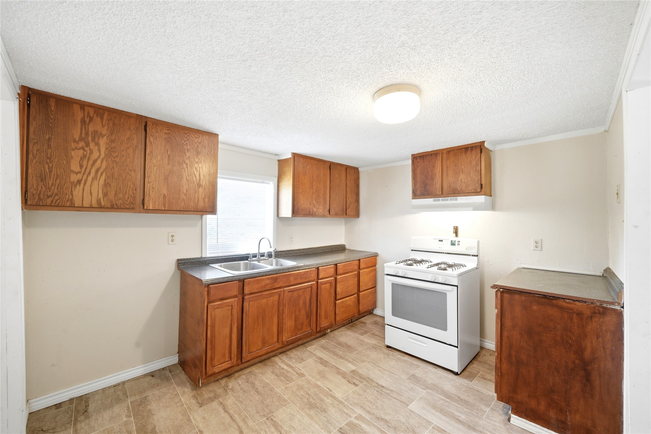 101 Outlar Street Wharton, TX 77488 - Photo 8 of 40 a kitchen with a stove top oven sink and cabinets
