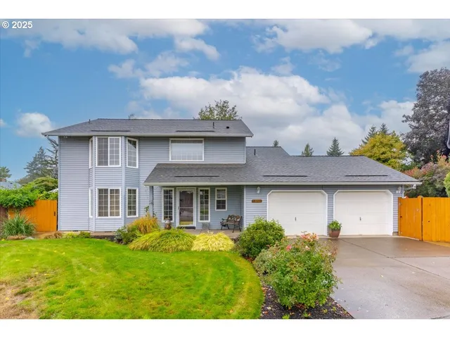 a front view of a house with a garden