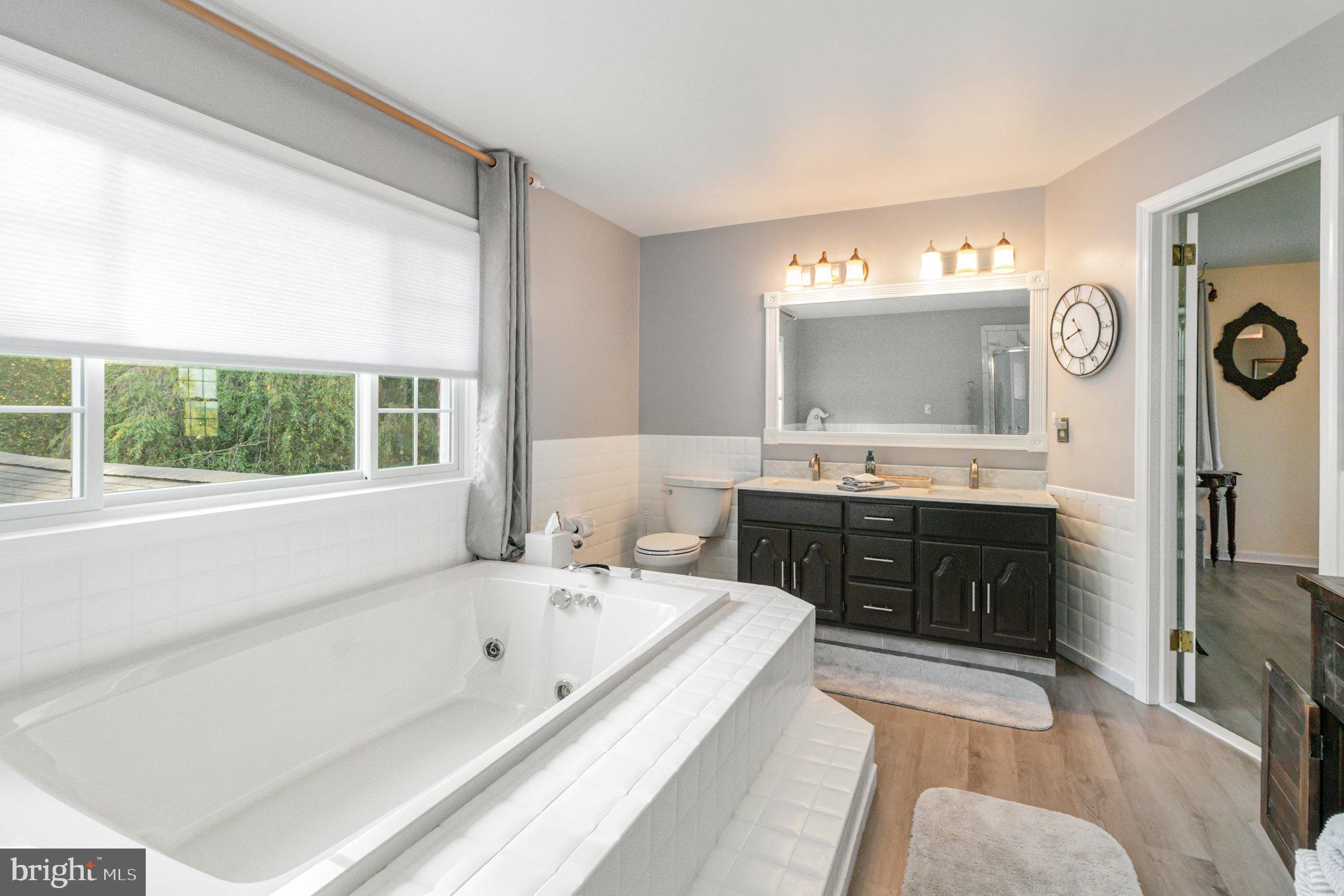 124 South Ridge Road Boiling Springs, PA 17007 - Photo 29 of 56 a spacious bathroom with a tub a double vanity sink and a large mirror
