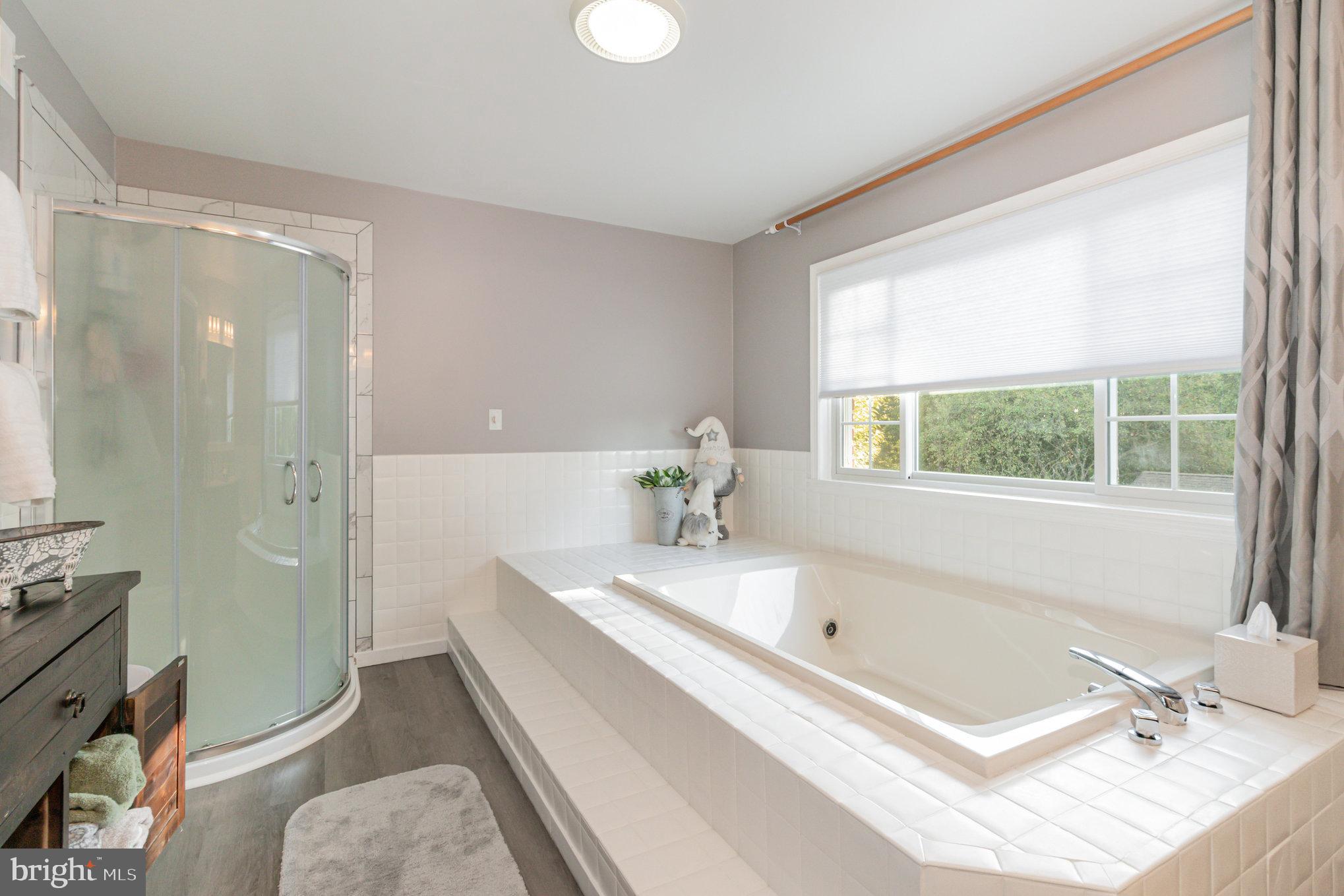 124 South Ridge Road Boiling Springs, PA 17007 - Photo 30 of 56 a bathroom with a tub a sink and a window