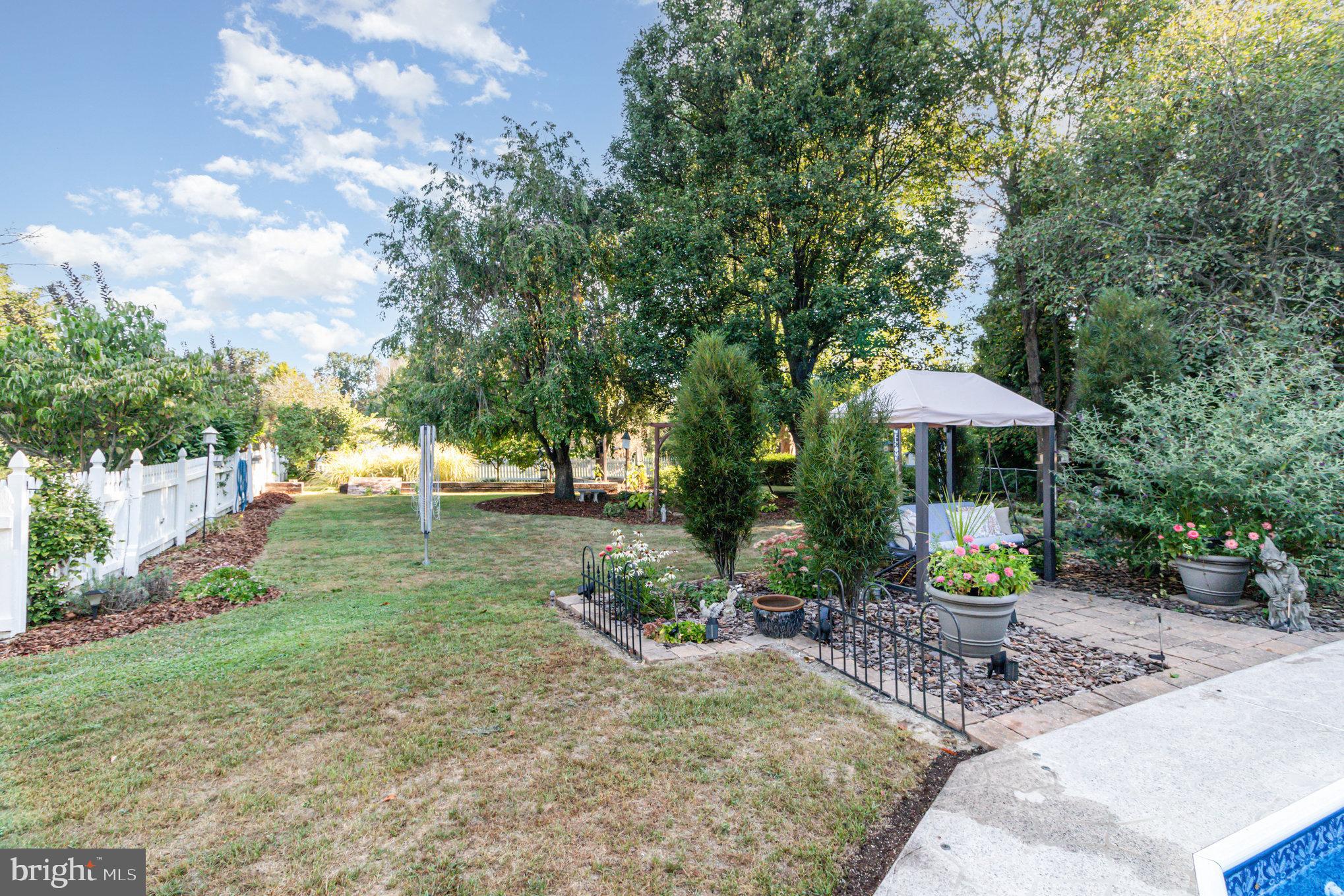 124 South Ridge Road Boiling Springs, PA 17007 - Photo 36 of 56 a view of a backyard with table and chairs under an umbrella