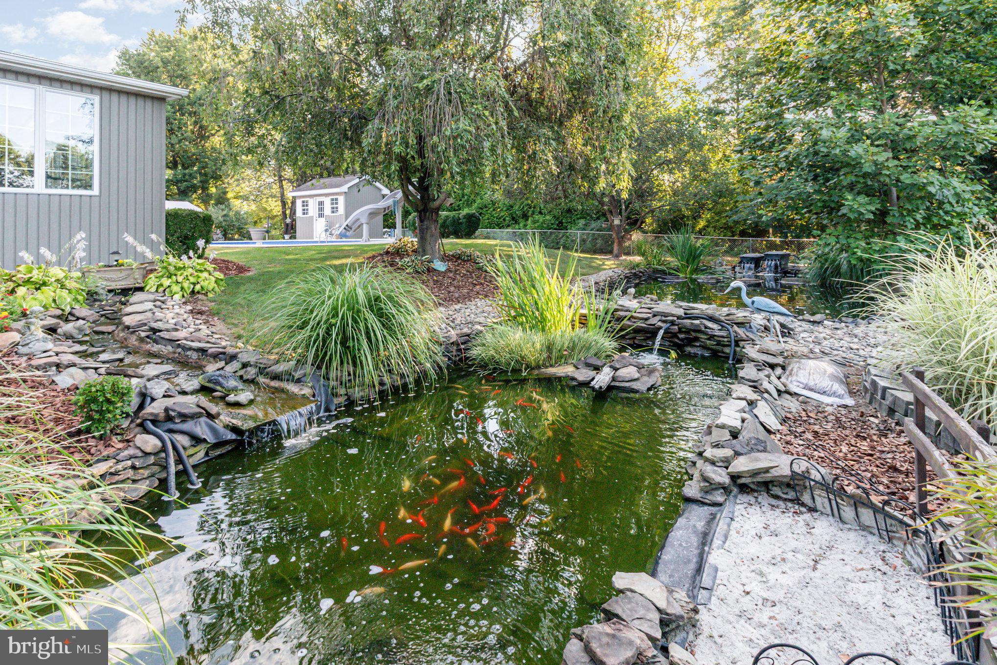 124 South Ridge Road Boiling Springs, PA 17007 - Photo 43 of 56 a backyard of a house with a garden and outdoor seating