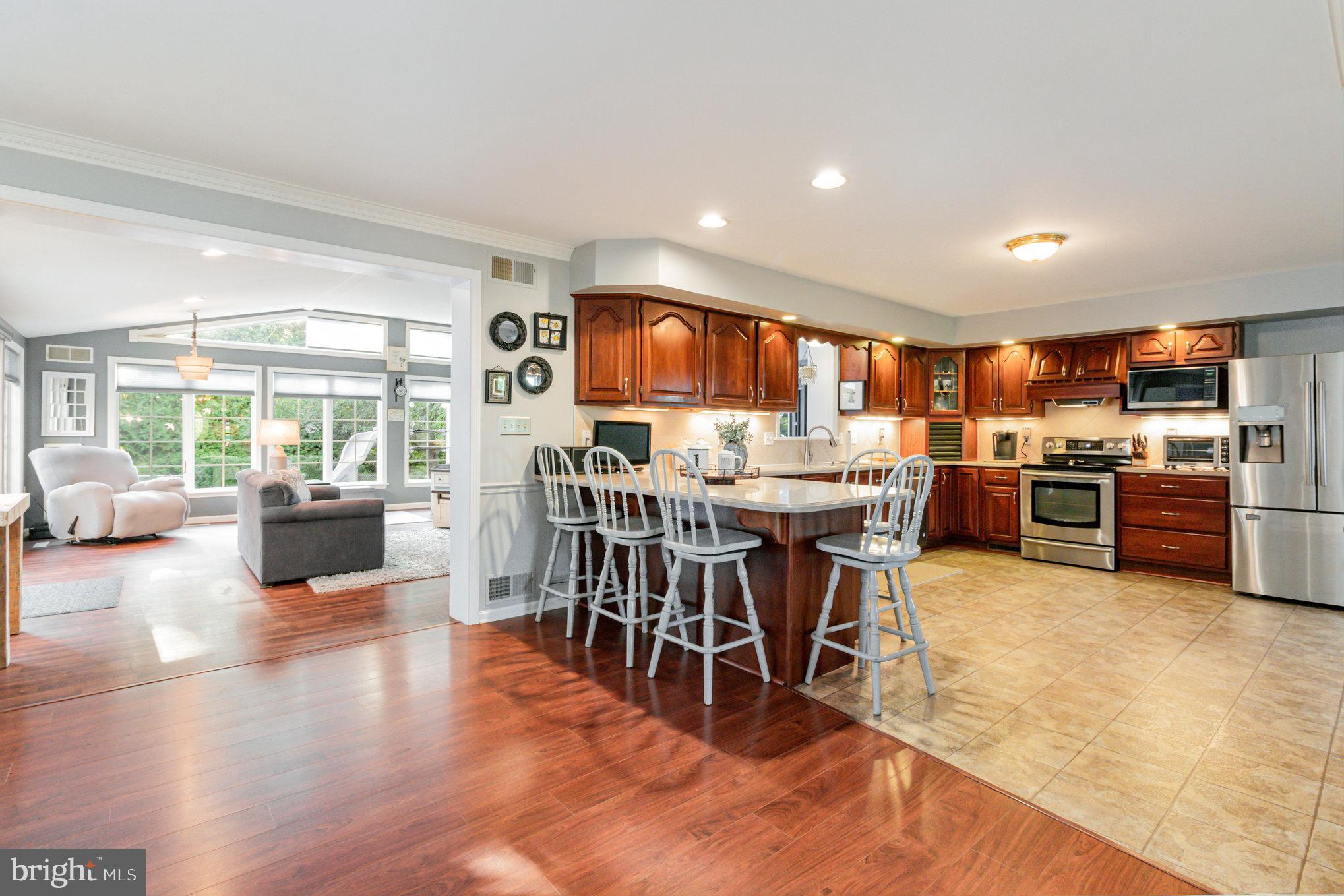 124 South Ridge Road Boiling Springs, PA 17007 - Photo 7 of 56 a living room with stainless steel appliances furniture wooden floor and a kitchen view